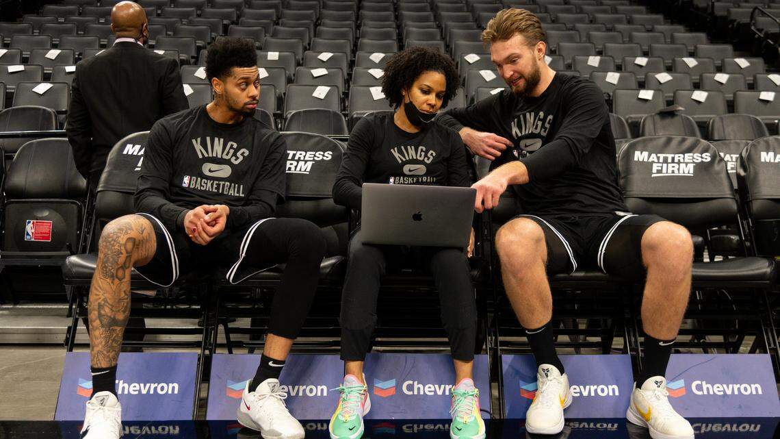 Sacramento Kings center Domantas Sabonis (10), right, and Sacramento Kings guard Jeremy Lamb (26) talks with assistant coach Lindsey Harding before a game at Golden 1 Center on Wednesday, Feb. 9, 2022 in Sacramento.