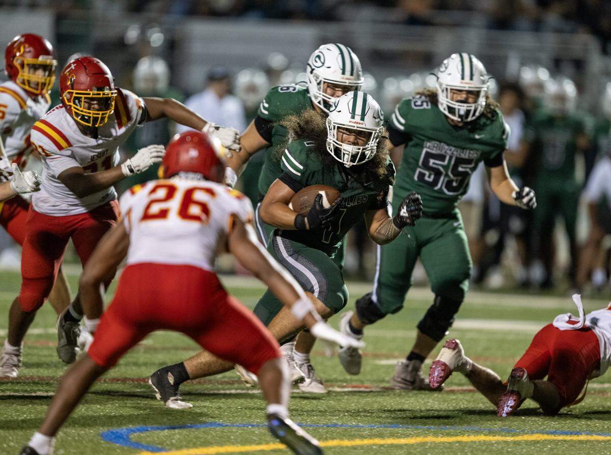 The Granite Bay Grizzlies' Isaiah Ene (1) runs for a touchdown past the Jesuit Marauders' defense in Granite Bay in September. 