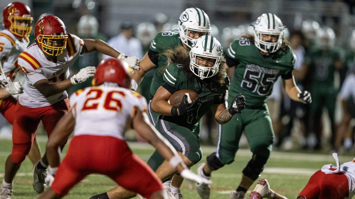 The Granite Bay Grizzlies' Isaiah Ene (1) runs for a touchdown past the Jesuit Marauders' defense in the second half on Friday in Granite Bay.