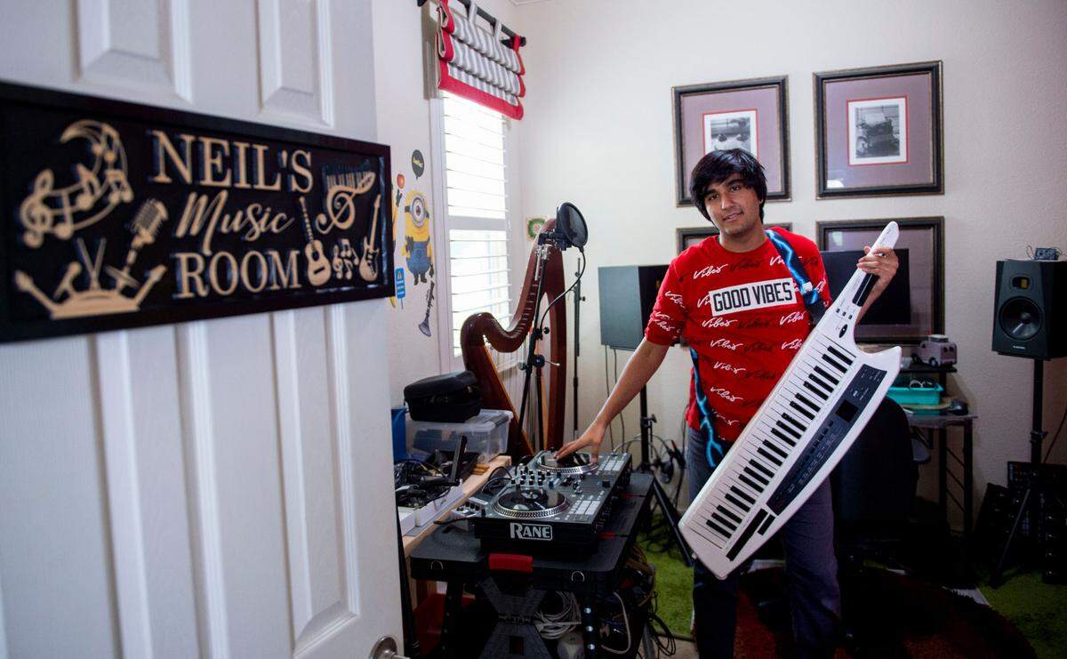 Neil Nayyar holds a keytar while standing in his music room at his home in Elk Grove on May 6. The 16-year-old plays over 100 musical instruments and is featured in a new Honda ad campaign.
