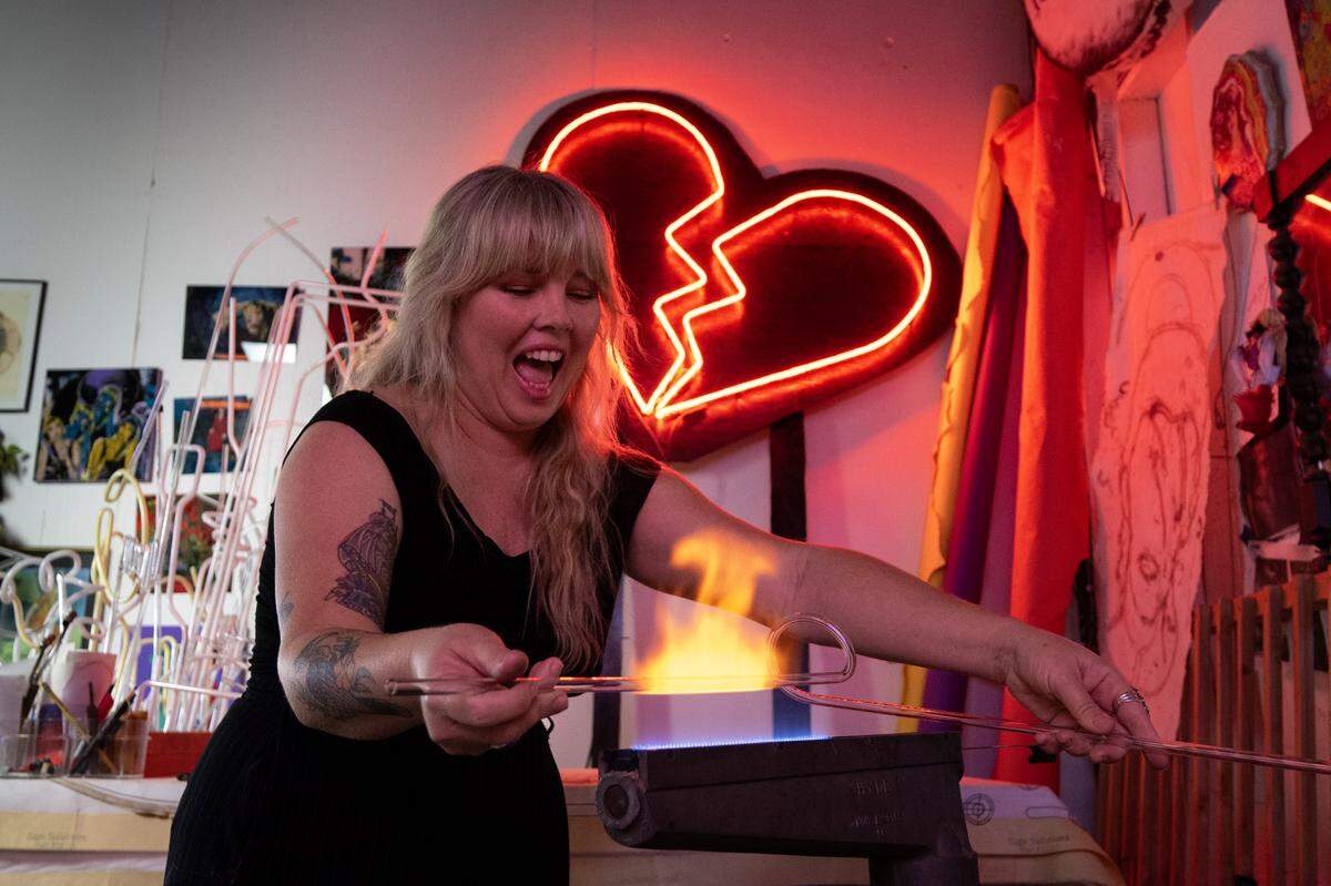 Neon tube artist Mellissa Uroff shapes a neon tube in her Sacramento studio on Tuesday.