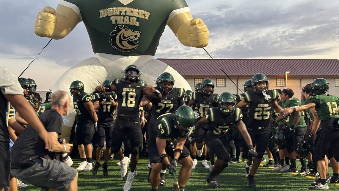 The Monterey Trail football team enters its home field before the season opener Friday against Inderkum in Elk Grove. Monterey Trail prevailed, 27-22.