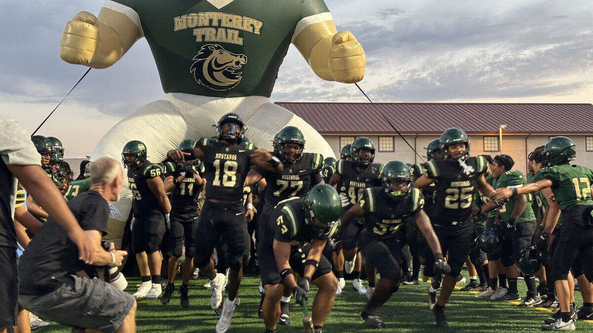 The Monterey Trail football team enters its home field before the season opener Friday against Inderkum in Elk Grove. Monterey Trail prevailed, 27-22.