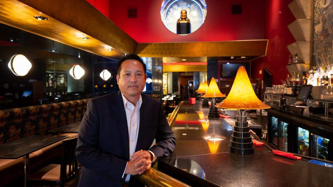 Kevin Fat, CEO of the Fat Family Restaurant Group, stands at the bar in Frank Fat’s, the restaurant his grandfather opened in 1939, in downtown Sacramento on May 25, 2023.