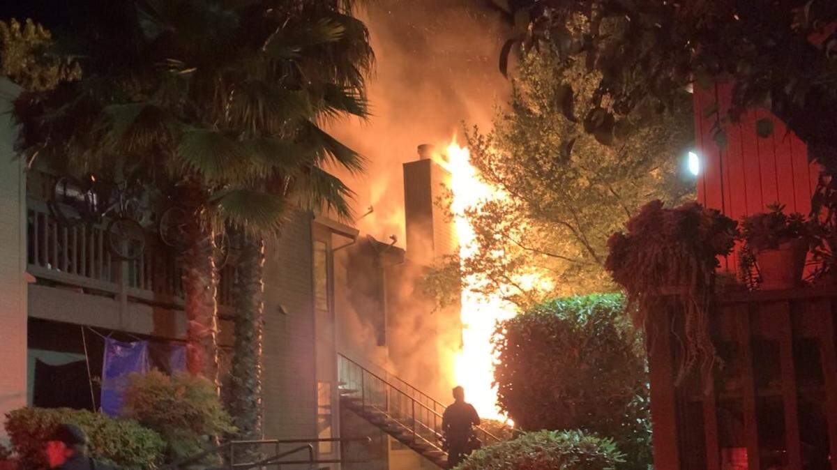 A fire rages at an apartment complex in North Highlands on June 24, 2022. A man barricaded himself and his 1-year-old son hostage in the apartment during informal visitation, and then it on fire.
