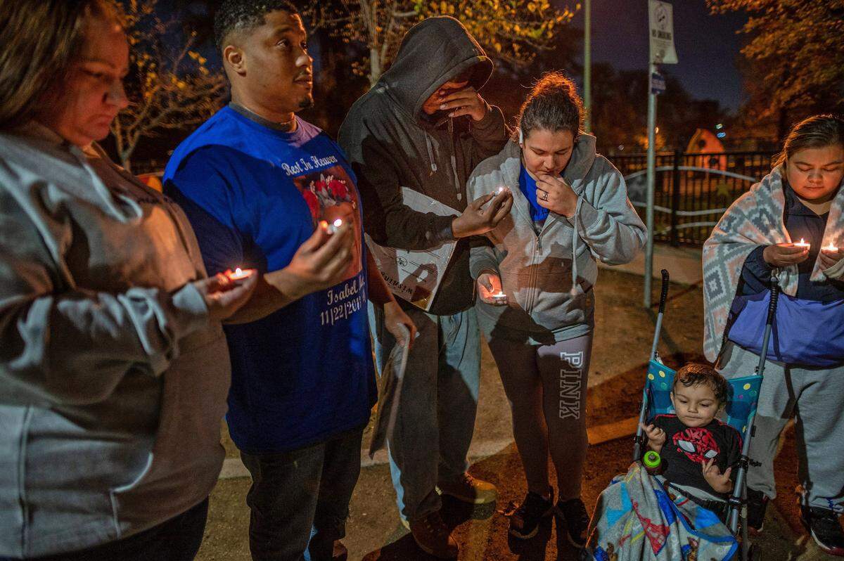 Brandon Martin, center, wipes tears as he stands with his wife Monica Delgadillo and son Brandon, 2, on Monday, Nov. 22, 2021, during a prayer vigil and celebration of life for his daughter Isabel Delgadillo Martin at Southside Park. Isabel would have turned 8 on that day, but she was killed in a Nov. 16 shooting in Upper Land Park. Family friends Tamra and Caesar Gardner, far left, and Isabelís aunt Sonia, at right, joined the vigil. ìIt just hurts when something like this happens...tragedy to a little girl, someone so young to get their life snuffed out like that and for it to be your own family that it was caused by, itís confusing,î Caesar said. He said he held Isabel in his arms the day she was born and they share the same birthday. Isabelís uncle Tyrice Martin, 22, was arrested for the shooting that killed her and a man in Upper Land Park.