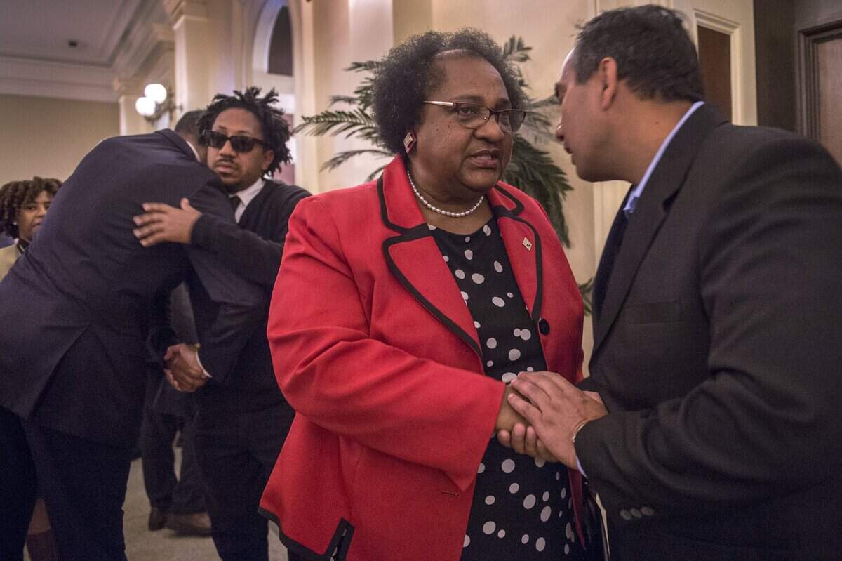 Assemblywoman Shirley Weber, shares a moment with Raj Manni, the grandfather to Stephon Clark's children as Clark's uncle, Kurtis Gordon is hugged after a press conference at the California State Capitol in Sacramento, Calif. Weber and Assemblyman Kevin McCarty introduced a bill that would tighten the state standard for use of lethal force to "necessary" when there are no alternatives for the officer to consider in that situation.