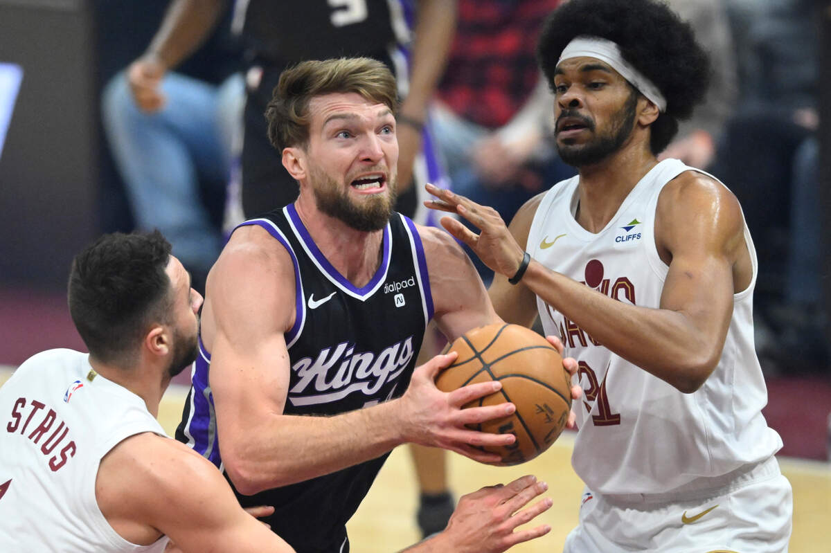 Sacramento Kings center Domantas Sabonis (10) drives between Cleveland Cavaliers guard Max Strus (1) and center Jarrett Allen (31) in the first quarter Monday, Feb. 5, 2024, at Rocket Mortgage FieldHouse in Cleveland, Ohio.