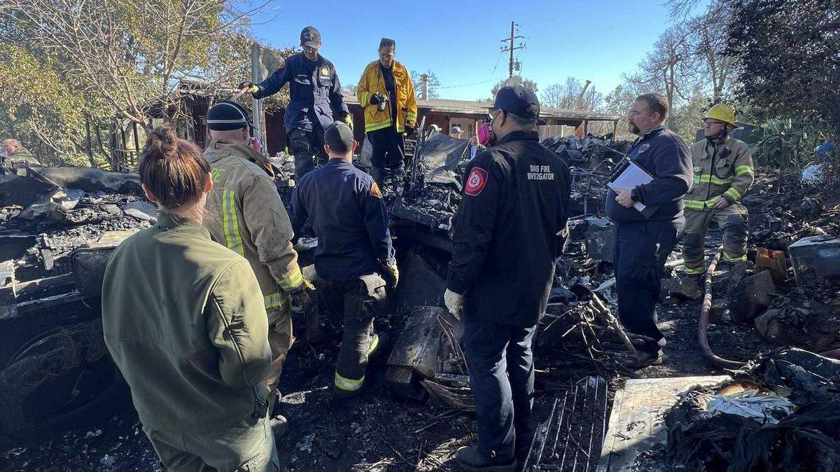 Fire investigators from several agencies work with the Sierra Arson Task Force at a fire in Guinda that left one person dead on Thursday, Jan. 23, 2025.