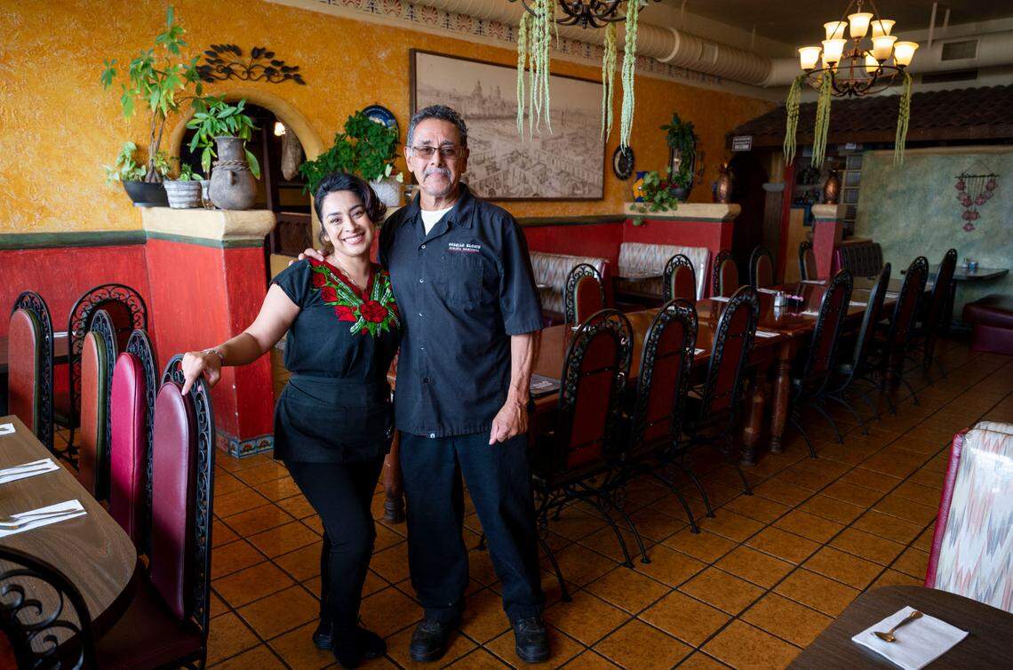 Urmilae Unzueta, left, stands with her dad Roy Unzueta, co-owner of Caballo Blanco restaurant in Sacramento’s South City Farms neighborhood Friday.
