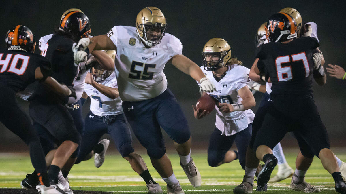 Elk Grove quarterback Ethan Archuleta (20) runs with a block from lineman Simione Pale (55) against Vacaville in a Nov. 12 playoff game. Pale signed with Stanford.