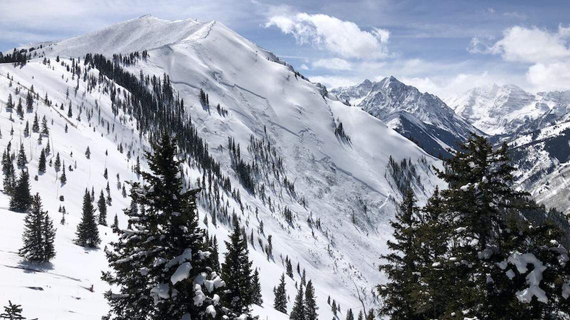 An avalanche engulfed three skiers, burying and killing one despite efforts to revive them, outside Aspen, Colorado officials say. 