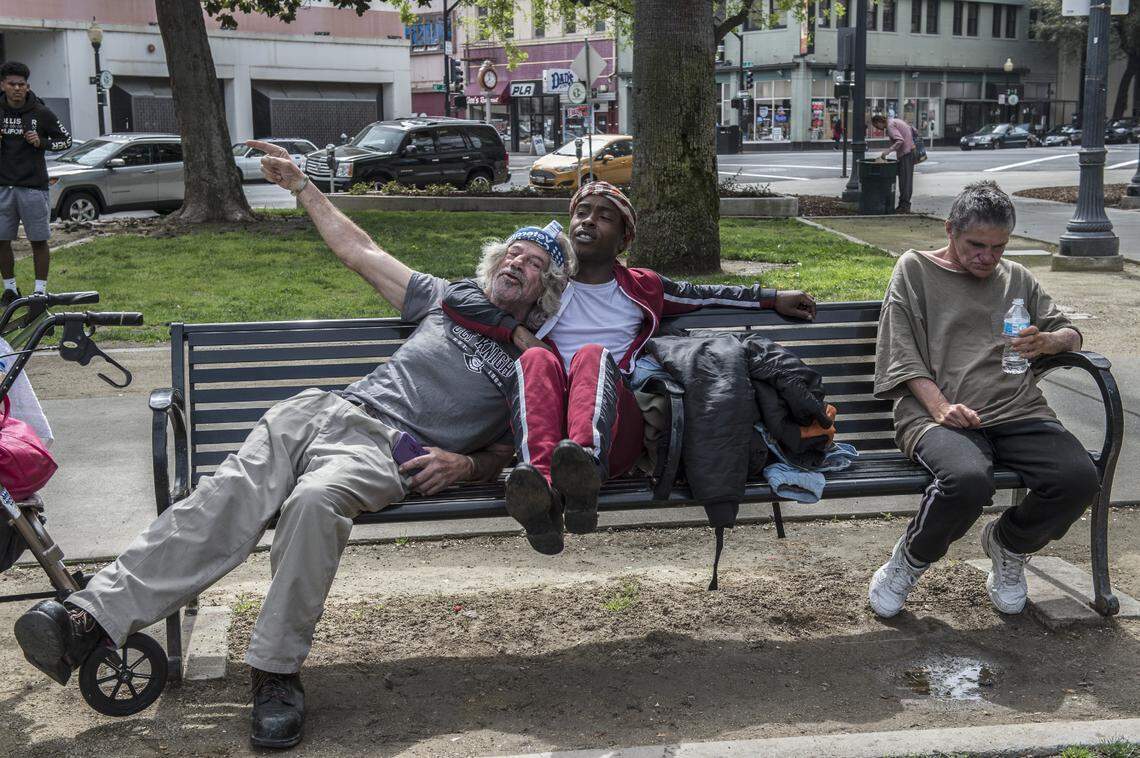 CORRECTED CAPTION: Stevante Clark hugs and kissed the head of John Burton Gay, a homeless man, before the Matt Barnes Rally in response to police shootings in Sacramento, Calif., on Sat., March 31, 2018. A family friend Jamilia Land who regards Clark as a nephew said he is suffering from post traumatic stress syndrome from the death of two brothers killed and that Sacramento needs more mental health professionals in this city. “This is what we should be focusing on in our community, getting these guys homes.” Clark said.