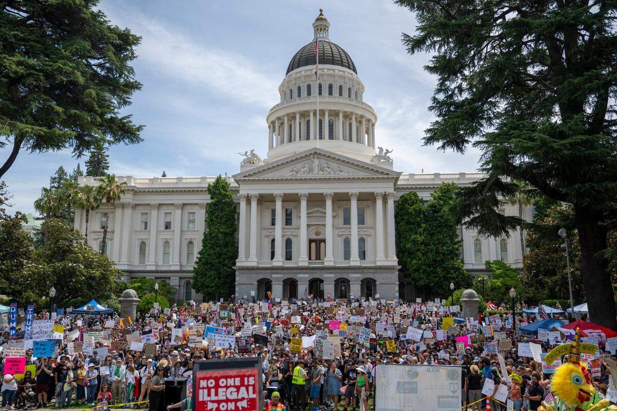 Demonstrators stand on the state Capitol west steps during the “No Kings” protest against the Trump administration in downtown Sacramento on Saturday, June 14 2025.