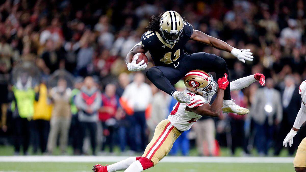 New Orleans running back Alvin Kamara hurdles 49ers free safety Jimmie Ward.