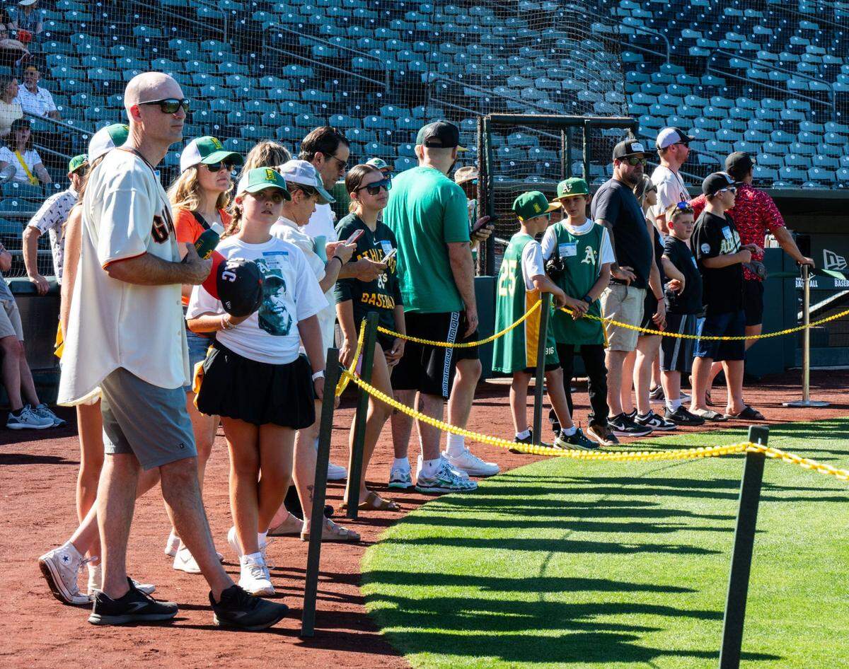 Athletics and Giants fans watch batting practice at Sutter Health Park in West Sacramento on Sunday.