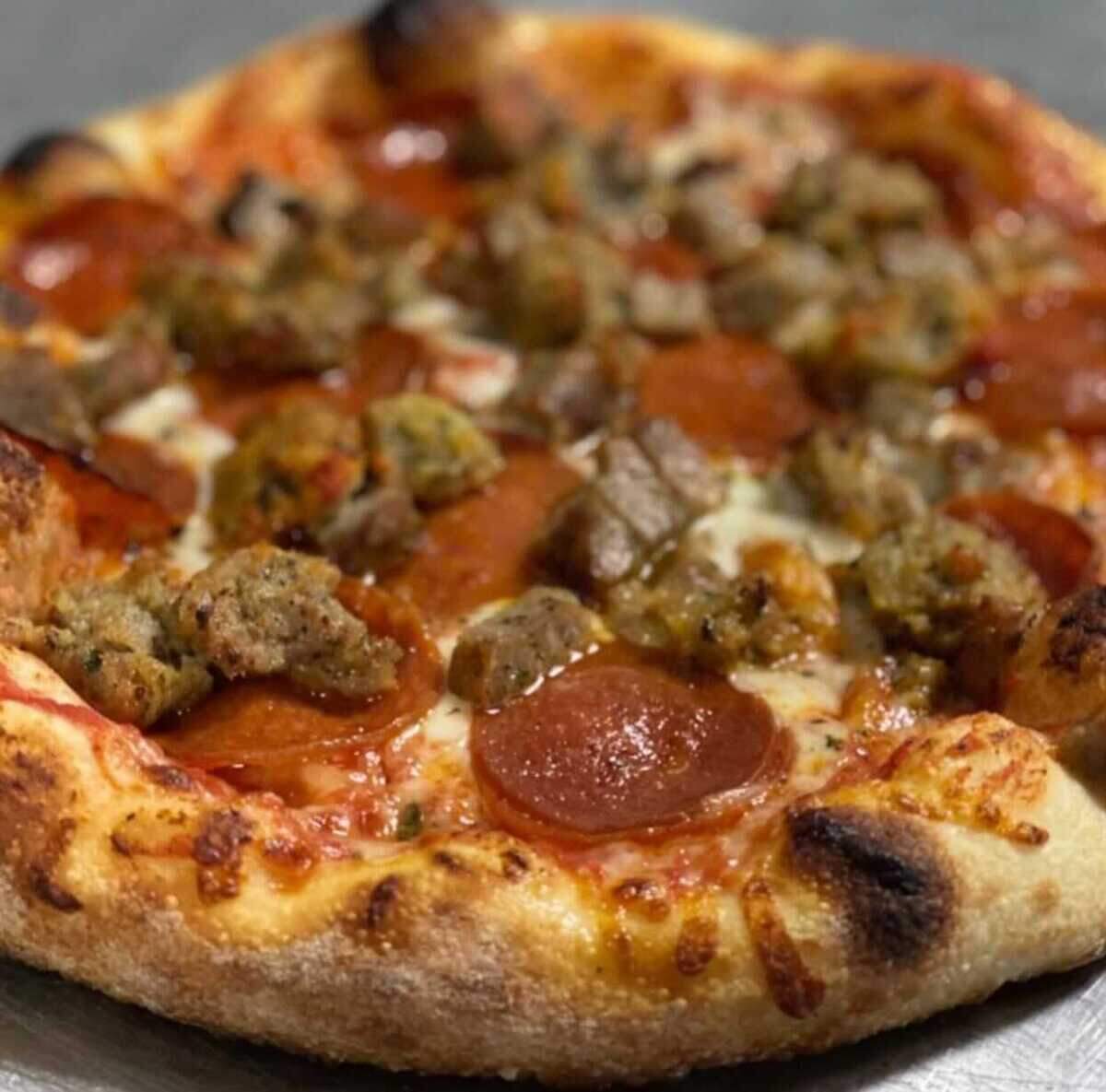 A pepperoni and sausage pizza made at Giovanni’s Old World New York Pizzeria, a New York style pizza shop in Sacramento.