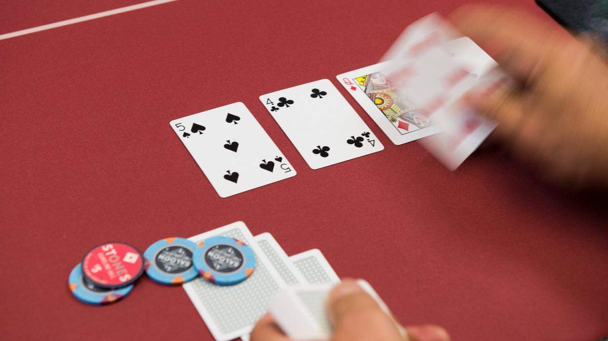 A card dealer deals the fifth community card (the river) in a game of Texas Hold’em at the Stones Gambling Hall in Citrus Heights, California on July 14, 2016.