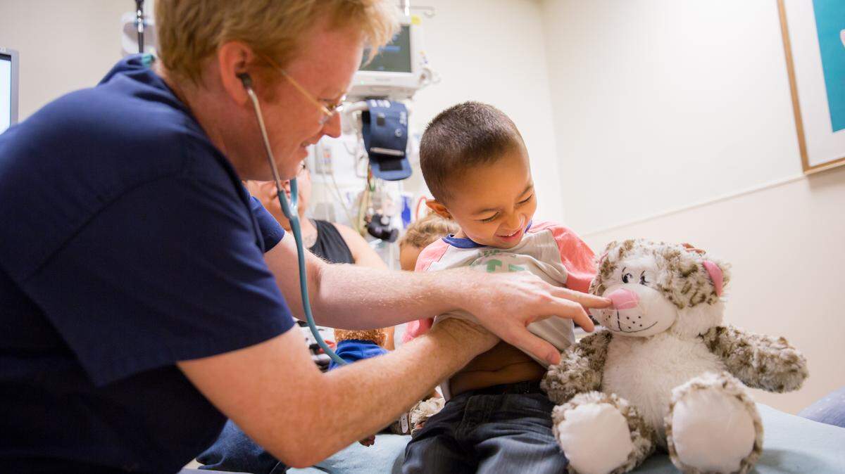 Dr. Paul Walsh, the medical director of Sutter Medical Center and a lead researcher on a recently released study that determined Ibuprofen is safe for infants, works with a young patient.