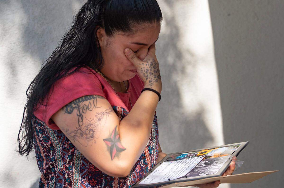 Allyssia Solorio cries on Sept. 6, after receiving a collages of photos and a message that her brother, Mikael Tirado, posted to Facebook a few months before he died from an accidental overdose from a pill that was illegally pressed as Percocet but contained fentanyl. Tirado’s family gathered in Rancho Cordova to mark the one-year anniversary of his death.