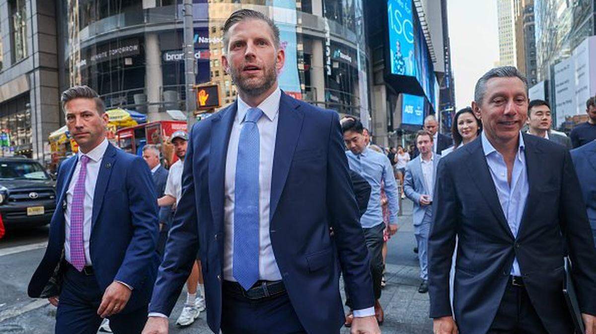 NEW YORK, NEW YORK - AUGUST 13: Eric Trump (left), the newly appointed ALT5 Board Director of World Liberty Financial walks outside of NASDAQ in Times Square as they mark the $1.5B partnership between World Liberty Financial (WLFI) and ALT5 Sigma with the ringing of the NASDAQ opening bell, on August 13, 2025 in New York City. The deal, in which ALT5 Sigma acquired 7.5 percent of the total WLFI token supply, marks a step in merging traditional finance with digital assets. (Photo by Spencer Platt/Getty Images)