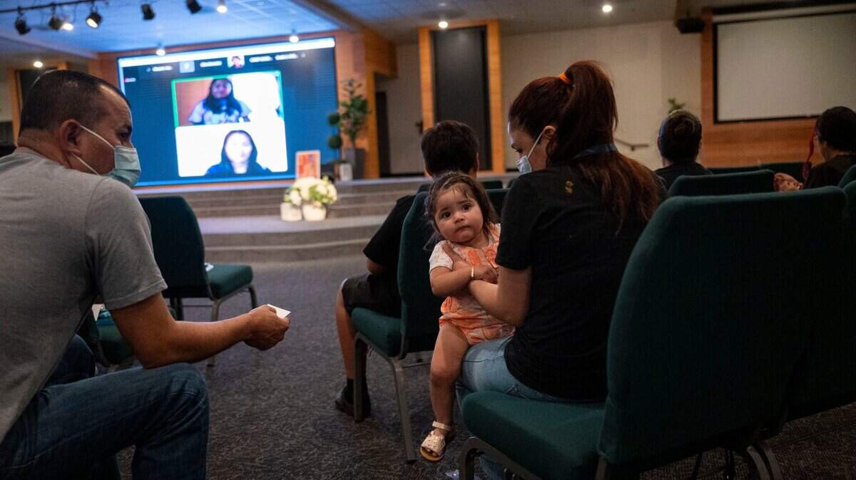 Cristobal and Lorena Aleman sit with one-year-old baby Mia Lopez in a Sacramento ACT town hall meeting centered around community schools at South Sacramento Christian Center on April 12.
