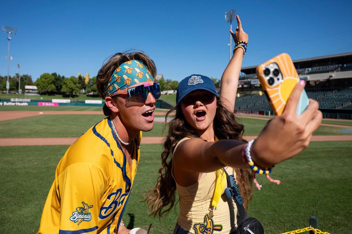 Savanna Bananas’ Jackson Olson (8) performs a TikTok with Marissa Clenney, of Oakley, 18, before the Savannah Bananas World Tour on Saturday, July 29, 2023, at Sutter Health Park in West Sacramento.