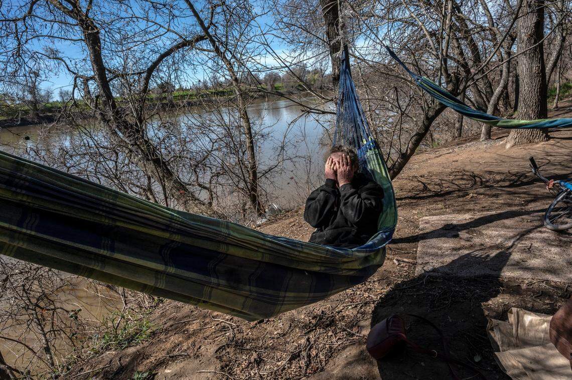 Catherine Roberts, 63, swings in her hammock in distress, trying to decide what to take and what to leave behind at the Bannon Island homeless encampment on Thursday. “They offered us until noon tomorrow to get out but they haven’t offered us any shelter, nothing. Don’t know where to go,” said Roberts who has two dogs and a cat.