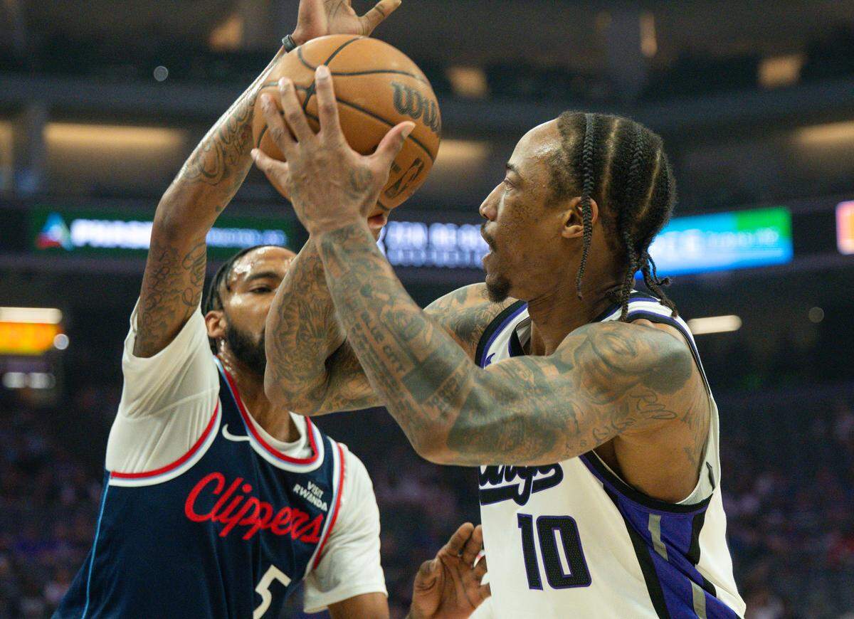 Sacramento Kings guard-forward DeMar DeRozan (10) takes a shot as Los Angeles Clippers forward Derrick Jones Jr. (5) during the first quarter at Golden 1 Center on Sunday, April 5, 2026. DeRozan passed Oscar Robertson on the NBA all-time scoring list midway through the quarter.