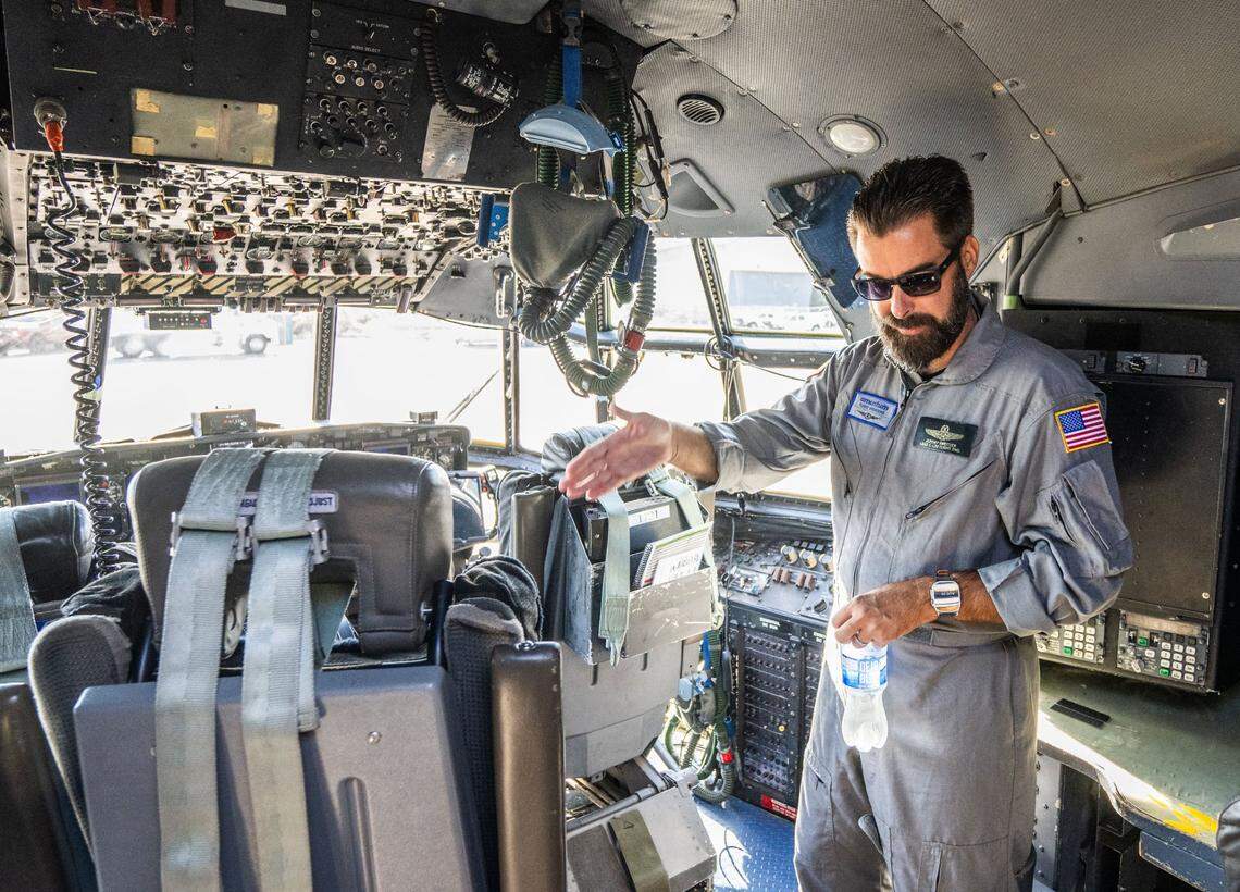 Jeremy Sweitzer, a lead C-130 flight engineer for Cal Fire, gives a tour of the newly converted air tankers on Thursday at McClellan Airport.