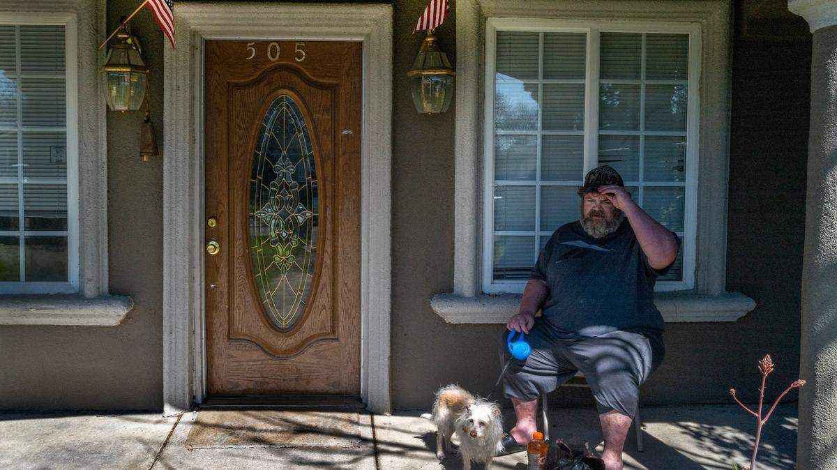 Kevin Haley, who suffers COPD and heart disease, rests drinking a gatorade with his 13-year old dog Danger at his Sacramento Self Help Housing home on Friday. He just moved into the house on Tenaya Street in North Sacramento on Tuesday. “I’ll be in big trouble,” he said if SSHH closes. “They haven’t said a word to us.”