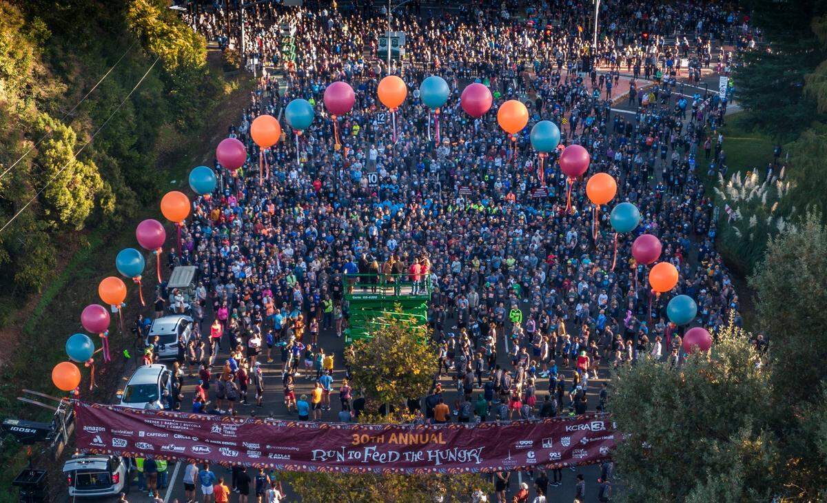 Participants of the 30th annual Run to Feed the Hungry prepare for the start of the race in East Sacramento on Thursday, Nov. 23, 2023.