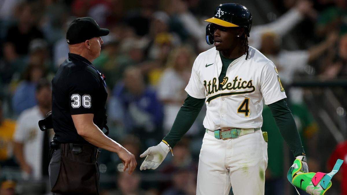 Jun 21, 2025; West Sacramento, California, USA; Athletics right fielder Lawrence Butler (4) discusses with home plate umpire Ryan Blankney (36) after getting ejected against the Cleveland Guardians during the fifth inning at Sutter Health Park. Mandatory Credit: Dennis Lee-Imagn Images