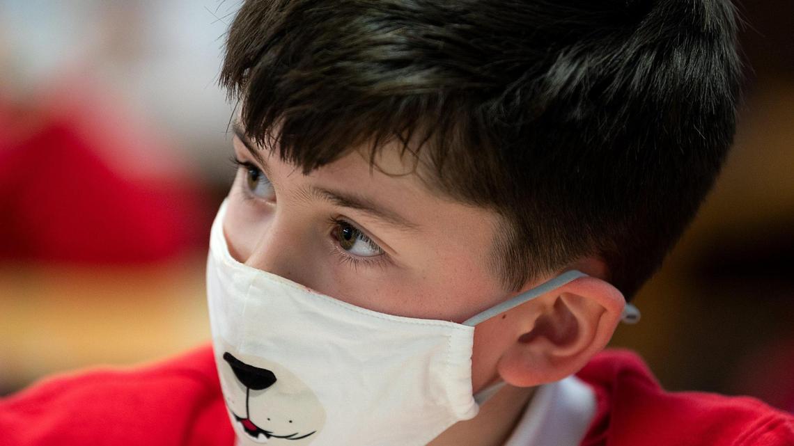 Joseph Markstein, 7, wears a face mask during his first grade class at Saint Philomene School last month in Sacramento.