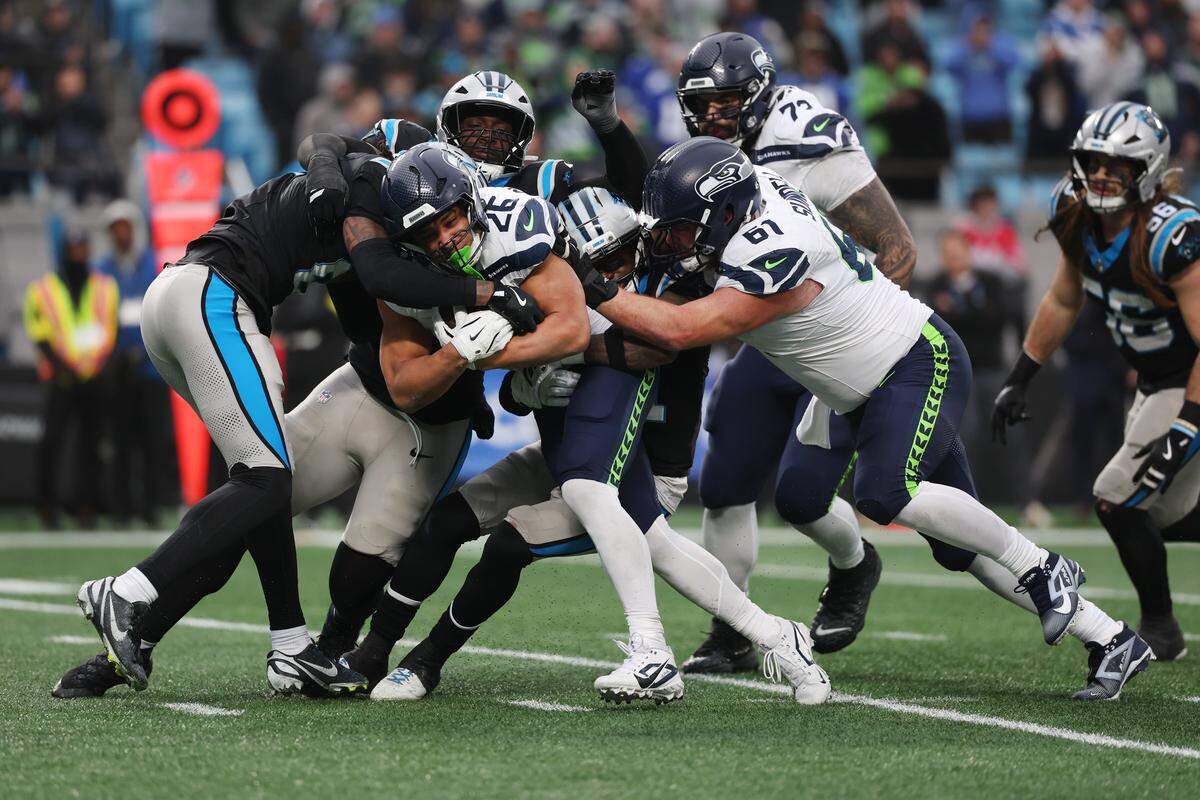 CHARLOTTE, NORTH CAROLINA - DECEMBER 28: Zach Charbonnet #26 of the Seattle Seahawks runs with the ball against the Carolina Panthers during the fourth quarter at Bank of America Stadium on December 28, 2025 in Charlotte, North Carolina. (Photo by David Jensen/Getty Images)