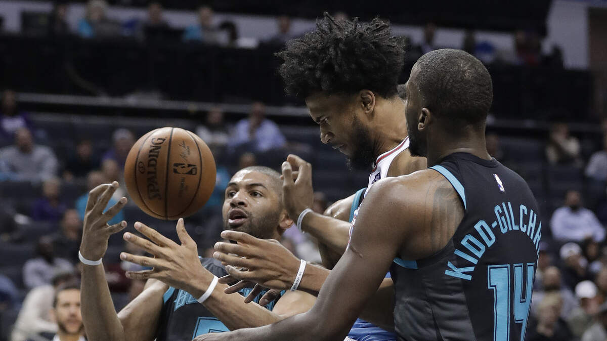 Kings big man Marvin Bagley III, center, goes for a rebound against Charlotte Hornets forwards Nicolas Batum, left, and Michael Kidd-Gilchrist on Thursday in Charlotte, N.C.