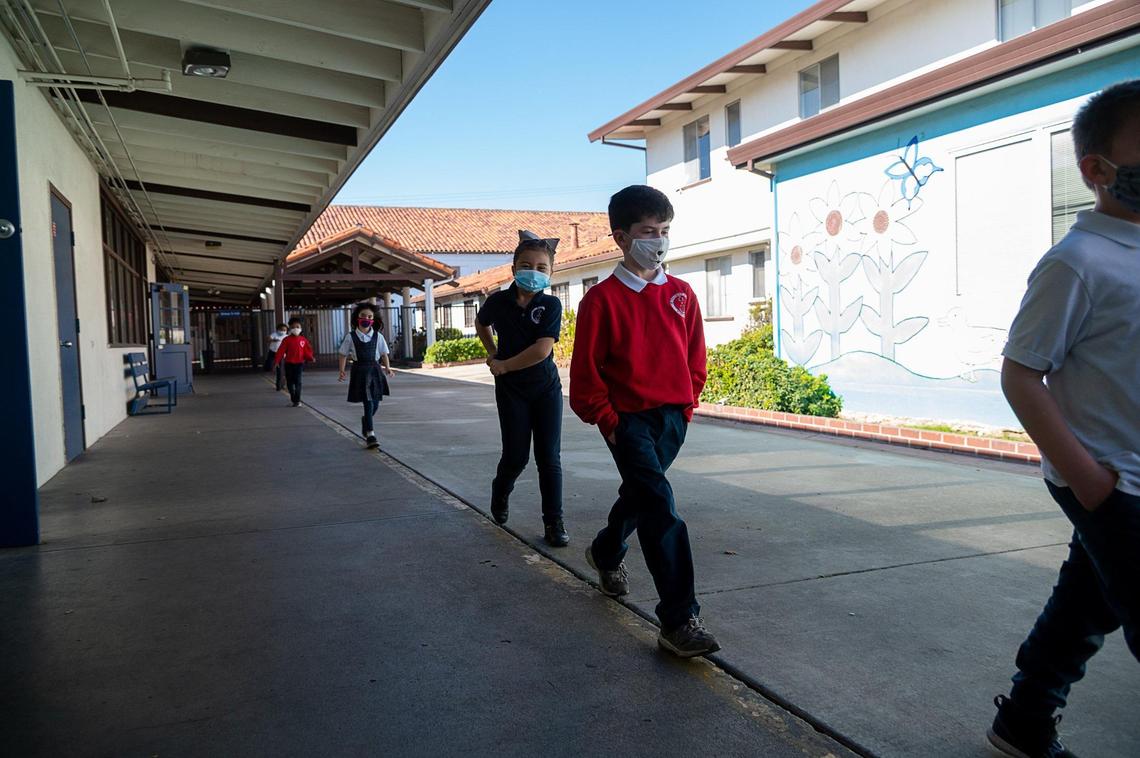 Joseph Markstein, 7, walks in a socially-distanced line back to the classroom with his classmates after a recess at Saint Philomene School on Wednesday, Feb. 10, 2021, in Sacramento.
