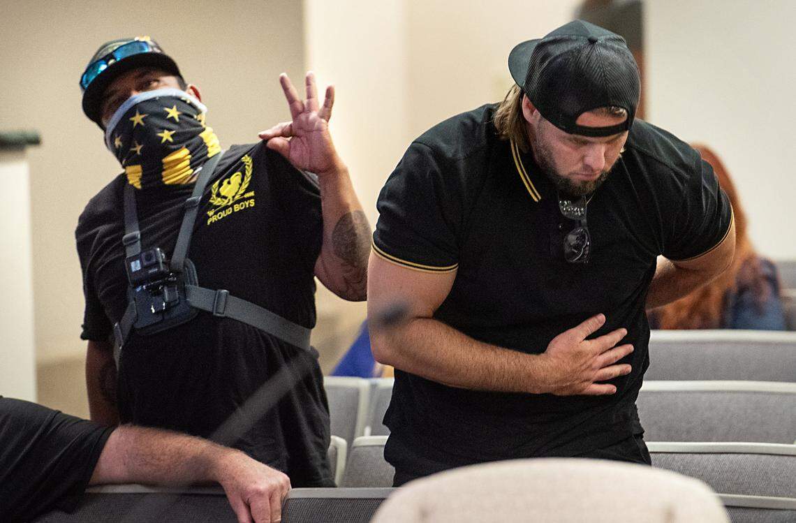 Proud Boy member Sean Adam K, right, responds to a public comment during the Modesto City Council meeting in June. Members of the far-right extremist group denounced the city’s efforts to look at potential reforms of its police department.