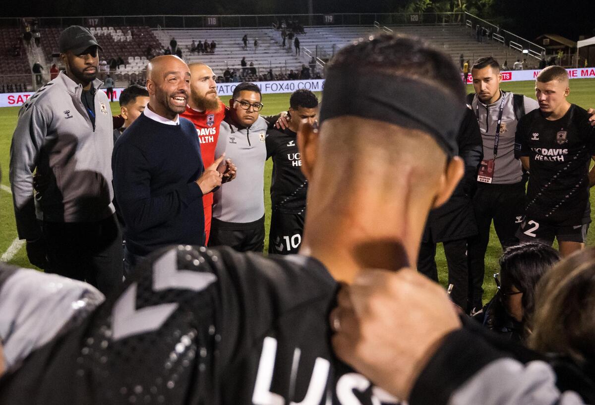 Sacramento Republic FC head coach Mark Briggs, left, speaks with his players and gives encouraging remarks after their 4-2 defeat to the Colorado Rapids in the U.S. Open Cup Round of 32 soccer match Tuesday, May 9, 2023, at Heart Health Park in Sacramento. Dried blood, sustained during an injury, can be seen on midfielder Luis Felipe’s neck at right.