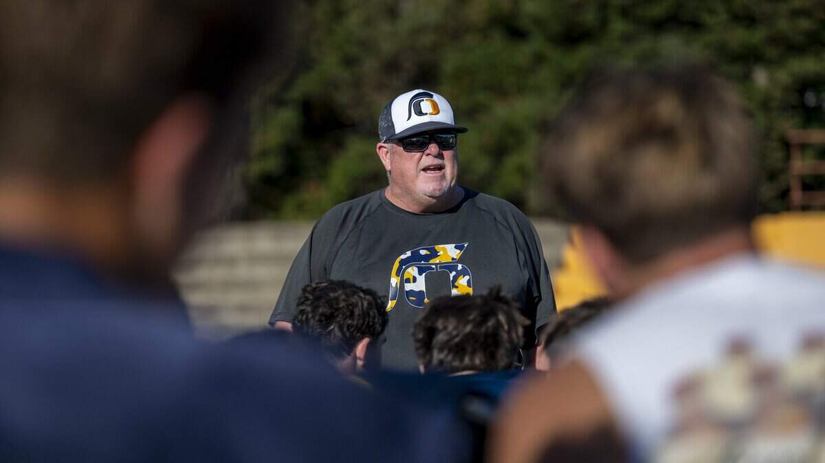 Head coach Casey Taylor speaks to his players after a football practice at Oak Ridge High School in El Dorado Hills on Aug. 5.