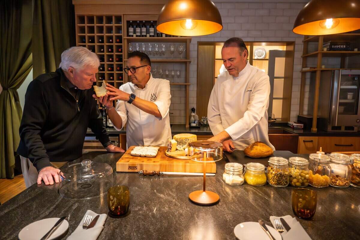 Russ Munson, left, the owner of Appellation Lodi - Wine & Roses Resort and Spa, samples cheese with Executive Chef Marco Fossati, center, and Chef Charlie Palmer, co-founder and CEO, in the dining room at Appellation Lodi - Wine & Roses Resort and Spa on Jan. 8, 2026.