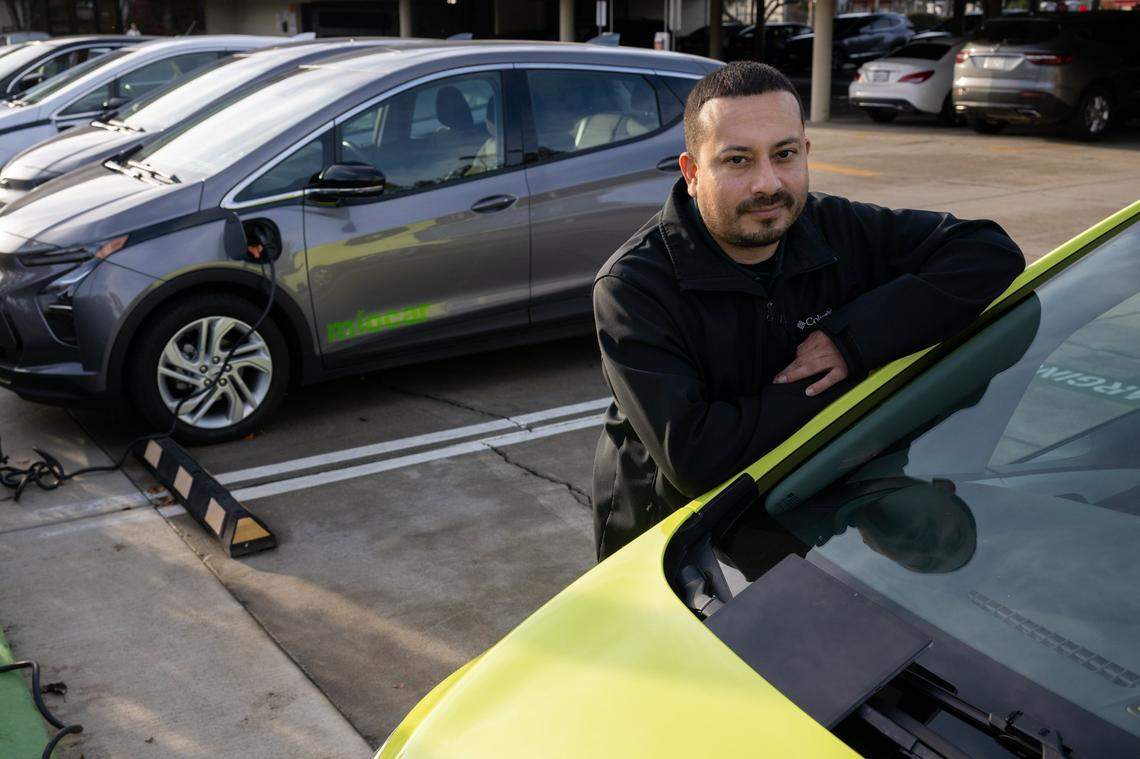 Míocar fleet manager Fernando González stands next to ride sharing electric cars ready for customers in Stockton in December. The nonprofit provides service for low income customers in the Central Valley.