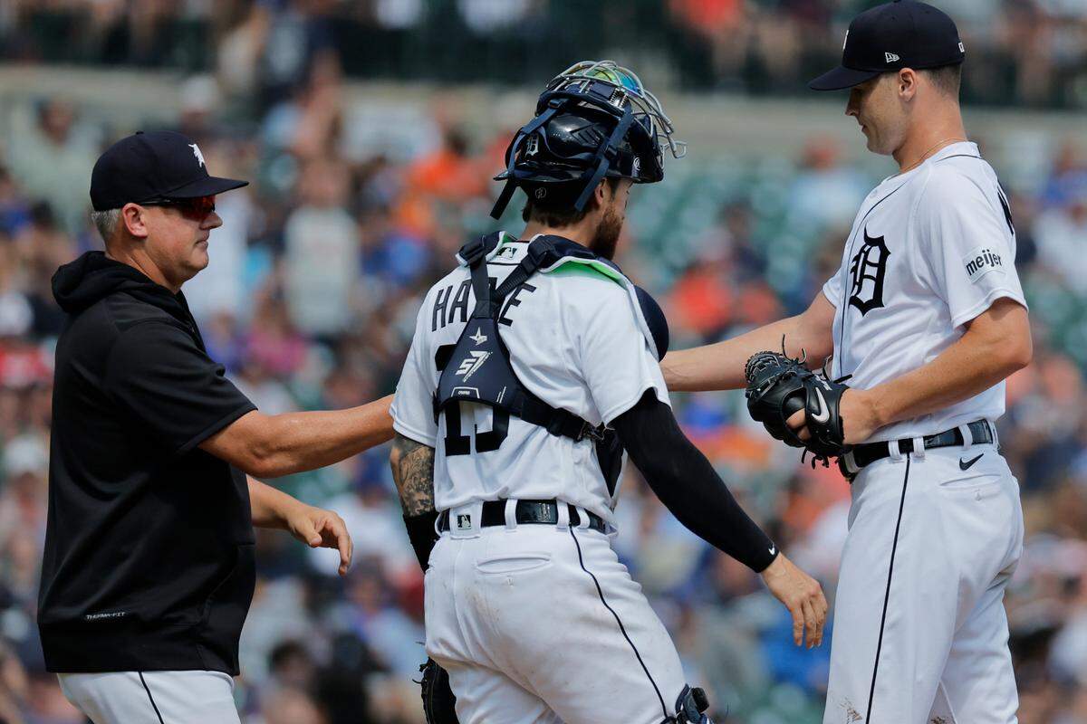 Detroit Tigers manager A.J. Hinch (left) takes the ball to relieve starting pitcher Matt Manning in the seventh inning against the Toronto Blue Jays on July 8, 2023, at Comerica Park in Detroit, Michigan.