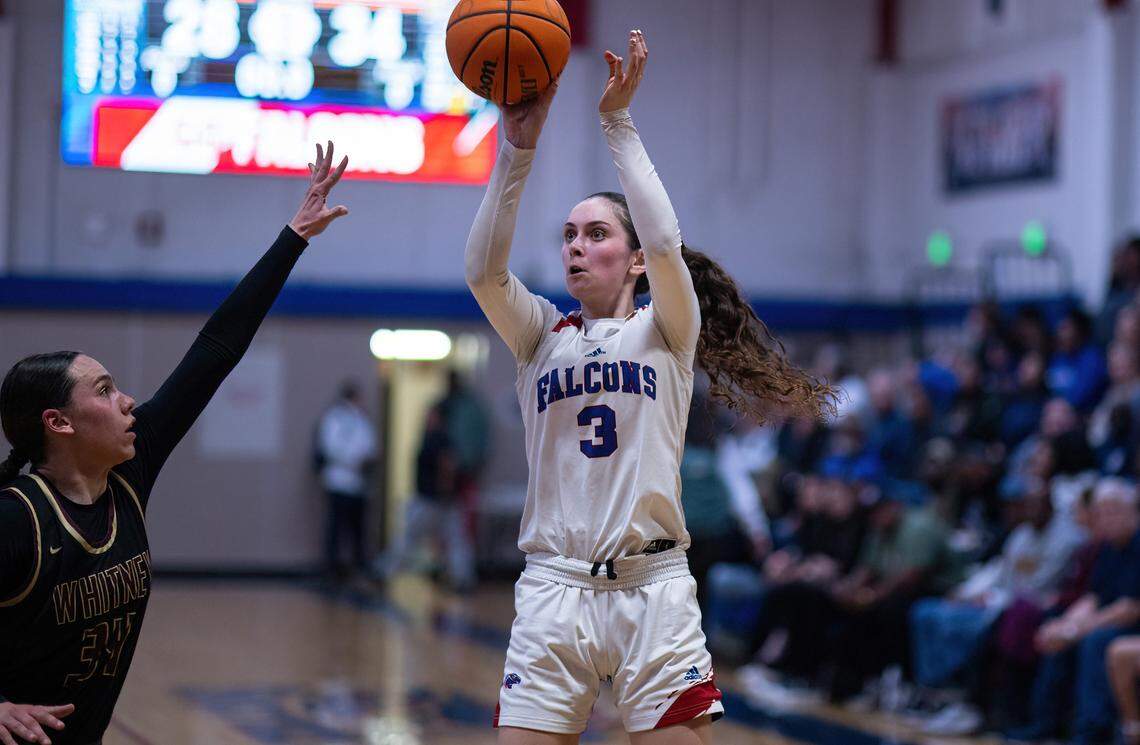 Christian Brothers Falcons guard Olivia Novi (3) shoots a 3-point shot as the Whitney Wildcats’ Natalia Benavidez (34) defends in a 2025 CIF Sac-Joaquin Section Division III semifinal girls basketball game.