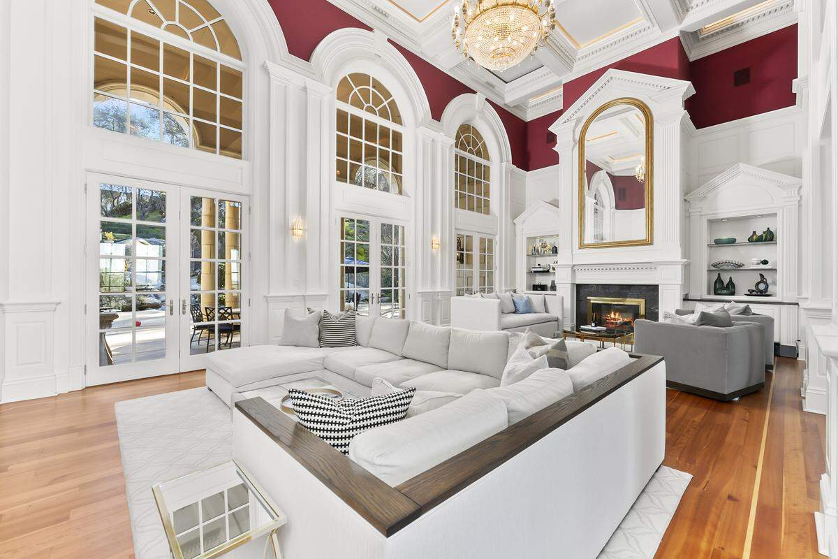 The scale of the home is evident right away with high ceilings and windows in the living room below a third-level catwalk.