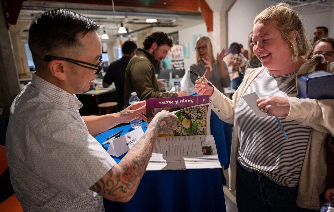 Chef Billy Ngo, left, signs “Sacramento Eats” books for local blogger Maddy Edmunds following the Sacramento Bee’s News & Nosh: An evening with chef Billy Ngo and food writer Benjy Egel on Tuesday, March 26, 2024.