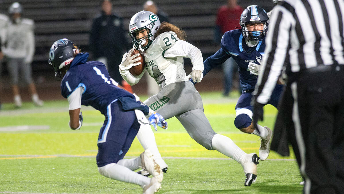 Granite Bay’s Isaiah Ene runs the ball during the CIF Sac-Joaquin Section Division II playoff game at Downey High School in Modesto, Calif., Friday, Nov. 11, 2022.
