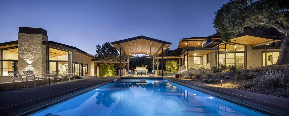 View decks and a reimagined barn with guest and office quarters into a self-contained hilltop compound in Carmel’s most guarded enclave.