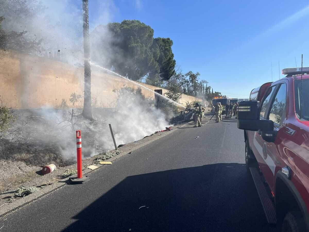 Sacramento Metropolitan Fire District personnel tend to a fire sparked from a Tesla electric car on Monday, Aug. 15, 2022. The driver of the vehicle was hospitalized.