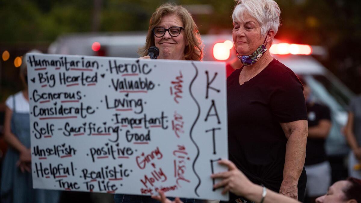 Mariann Fagunes, left, and Colleen Houk, both of Sacramento, speak warmly about their former colleague, Kate Tibbitts, during a vigil held in her honor at Plaza Cervantes Park on Thursday, Sept. 9, 2021, in Sacramento’s Land Park neighborhood. Authorities said they found Tibbitts, who was killed along with her two dogs, on the morning of Sept. 3 after her 11th Avenue home was set on fire by her killer.